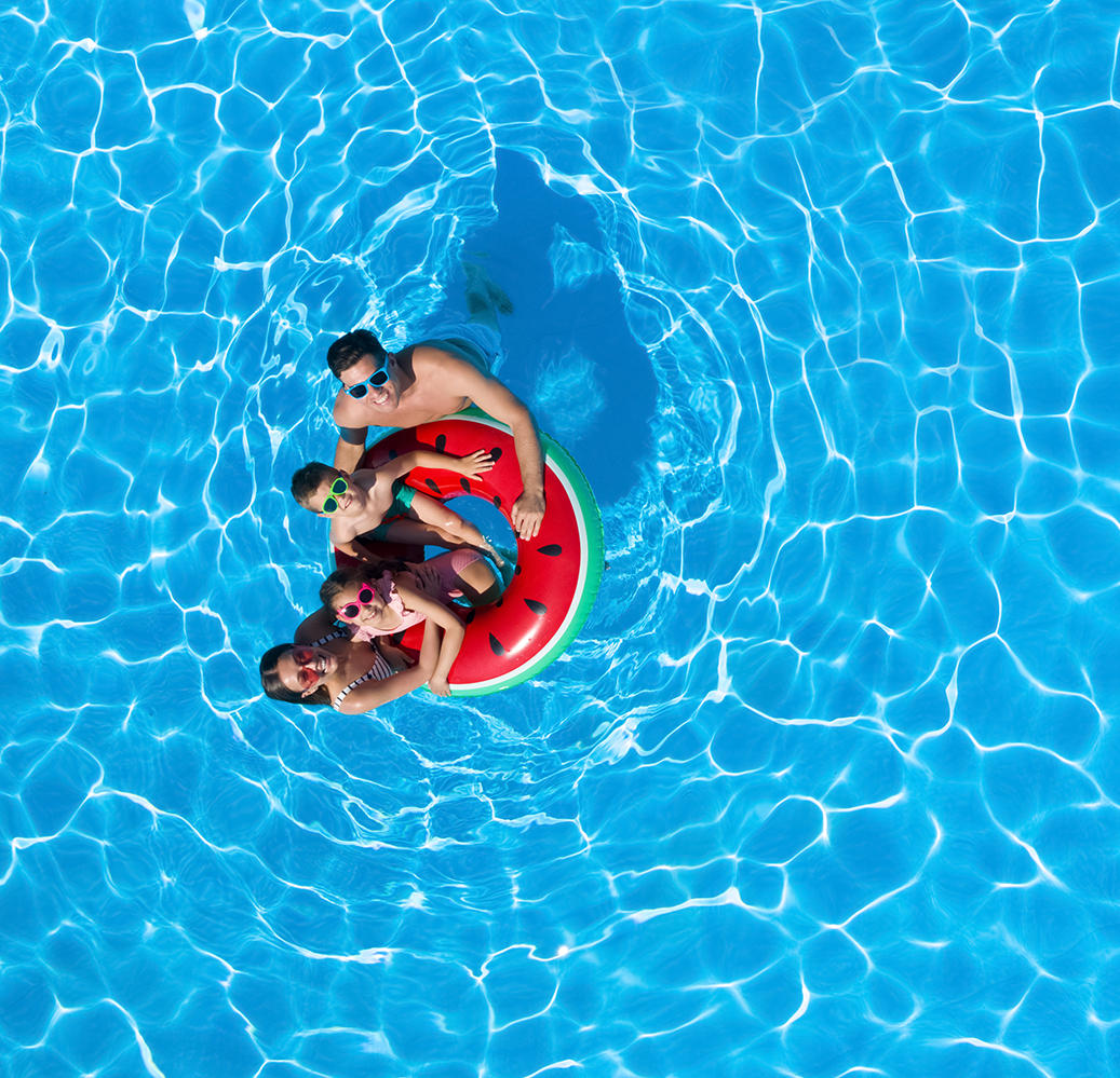 Family in pool looking up happy